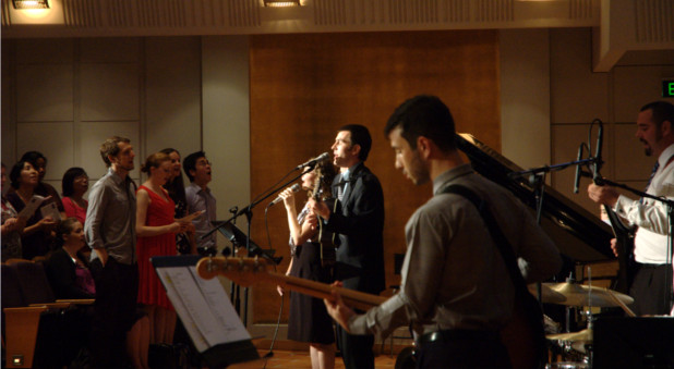 A band leads the singing of 'I Cannot Tell'