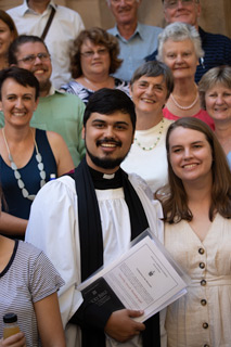 Tim Thambyrajah with his wife Hollie and congregation members
